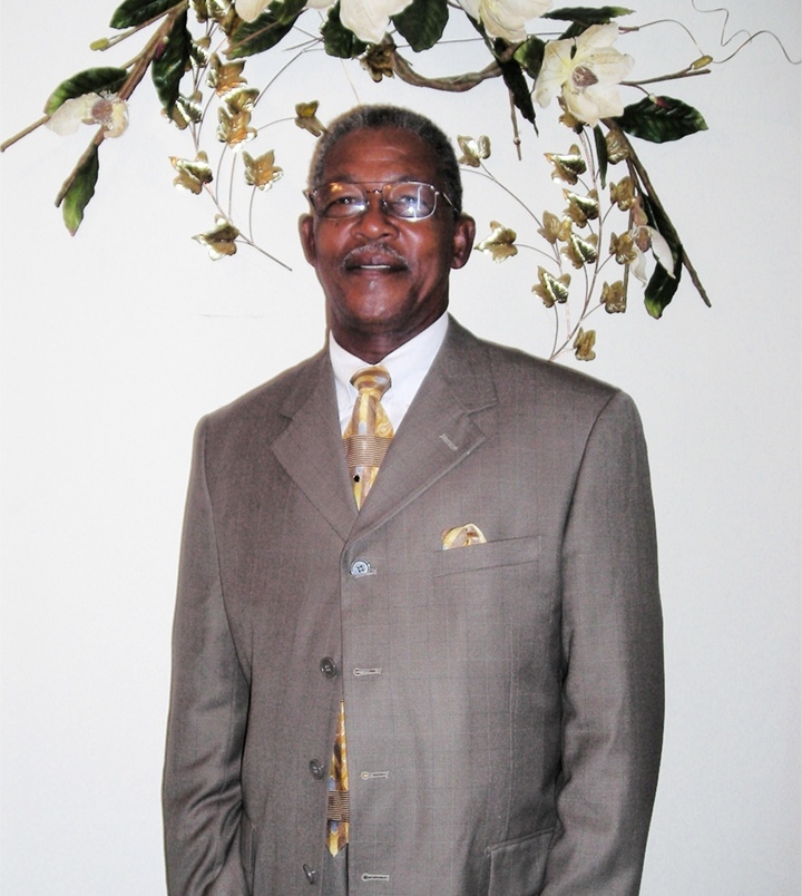 Pastor Randolph wearing a grey suit